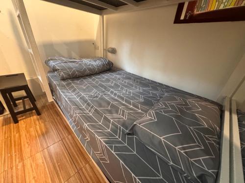 a bed in a small room with a bedspread on it at WELLNESS of KOH TAO in Koh Tao