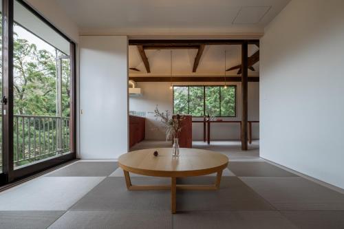 a living room with a table and large windows at Private Villa 3 minutes from bus stop - in the meantime in Hakone