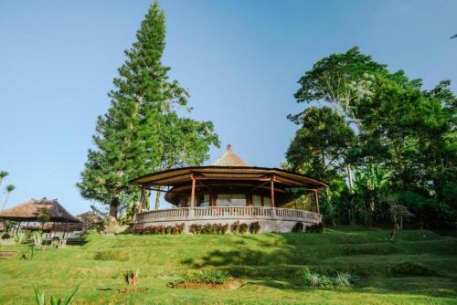 a large building on top of a green field at Bagus Jati Health & Wellbeing Retreat in Tegalalang