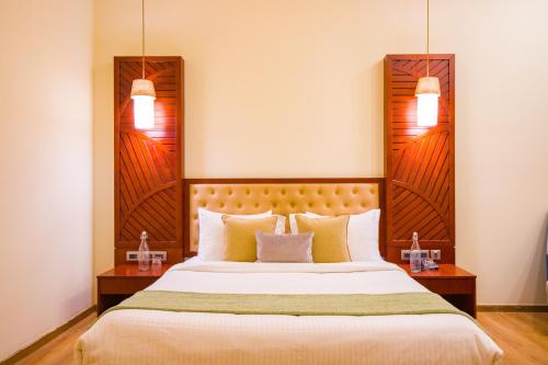 a bedroom with a large bed with two night stands at Eternal Oasis by Alaya Stays, Golf Course Road in Gurgaon