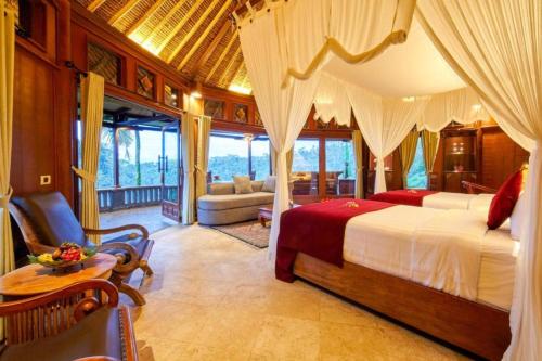 a bedroom with a bed and a living room at Bagus Jati Health & Wellbeing Retreat in Tegalalang