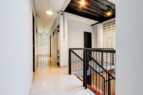 a hallway with a staircase in a house at Hotel O Rubina Syariah Hotel in Purbolinggo