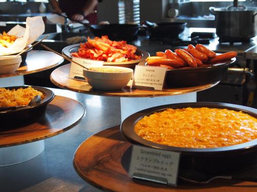 a display of different types of food on plates at Hotel Vison in Taki