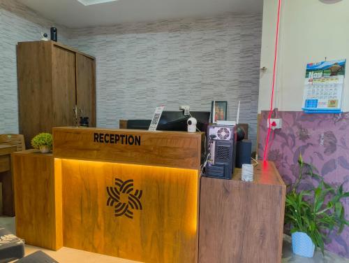 a reception desk in an office with a reception counter at Comfort INN in Payyannūr