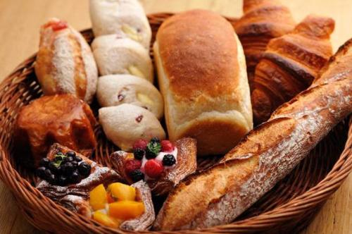 a basket of bread and pastries on a table at Hotel Vison in Taki
