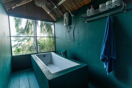 a bathroom with a white sink and a window at Leela Garden Resort Bubble house in Ban Nok