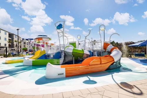a group of water slides in a water park at Villatel Orlando Resort in Orlando
