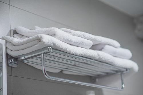 four towels on a towel rack in a bathroom at Terrace Akhaltsikhe in Akhaltsikhe