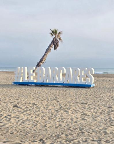 a sign on the beach with a palm tree at Torreilles-Casa terracota-plage - visa image- les déferlantes le Barcares - South of France in Torreilles