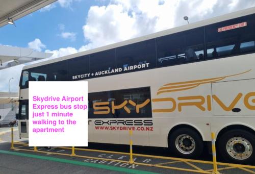 a double decker bus parked next to a sign at 180 Degrees Seaview and Harbor View 2 bedroom Apartment in Auckland