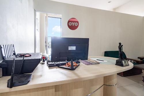 an office with a desk with a computer on it at Hotel O Tamansari Panoramic Apartment By Anwar in Bandung