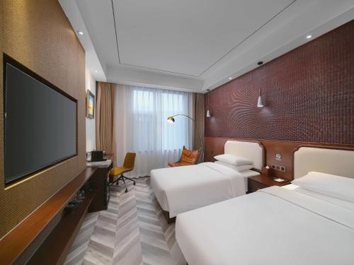 Ένα ή περισσότερα κρεβάτια σε δωμάτιο στο Park Plaza Hotel Beijing CBD Area By Radisson