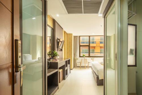 a hotel room with a bathroom and a bedroom at Jomtien Sands Residence in Jomtien Beach