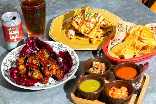 a table topped with plates of food and dips at Courtyard by Marriott Waikiki Beach in Honolulu
