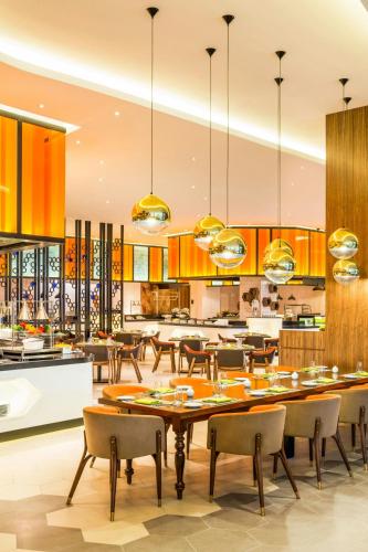 a dining room with a large table and chairs at Le Meridien Putrajaya in Putrajaya