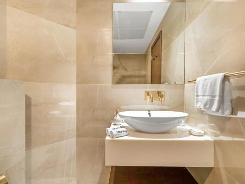 a bathroom with a white sink and a mirror at SmartStay at Zaya Hameni - Modern Luxury Apartments - Unique in JVC in Dubai