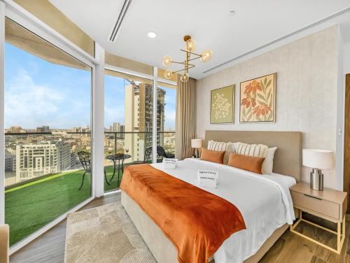 a bedroom with a large bed and a large window at SmartStay at Zaya Hameni - Modern Luxury Apartments - Unique in JVC in Dubai