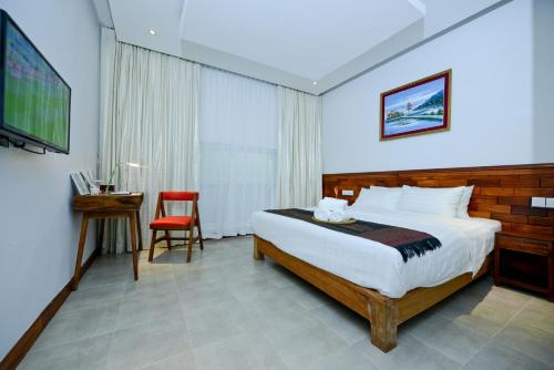 A bed or beds in a room at Mowin Boutique Hotel & Residence