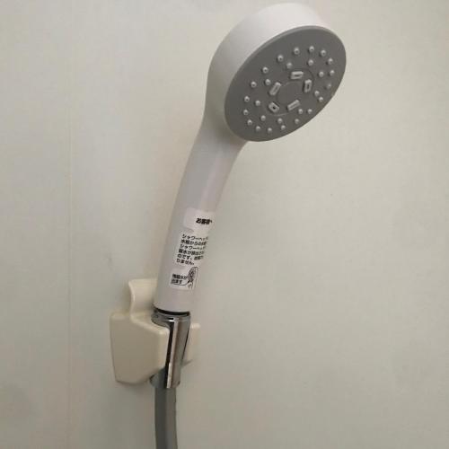a white hair dryer hanging on a wall at Okhotsk House Shari in Shari