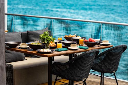 a table with bowls of food on a balcony at Hilton Hotel Tahiti in Papeete