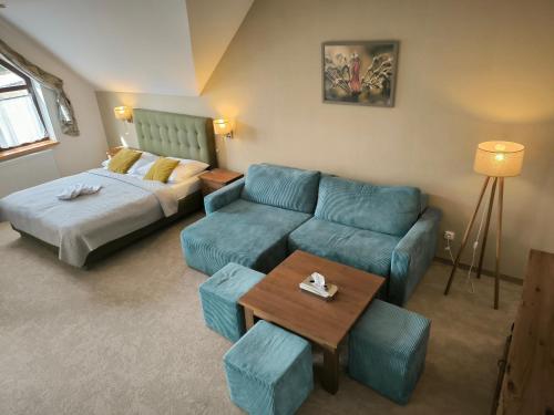 a living room with a couch and a bed at Wellness Pension 7 in Harrachov