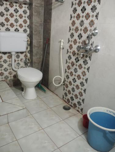 a small bathroom with a toilet and a shower at Ramashish kutir hotel in Banāras Cantonment