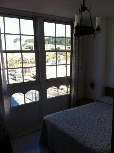 Ένα ή περισσότερα κρεβάτια σε δωμάτιο στο Hotel Pinzon