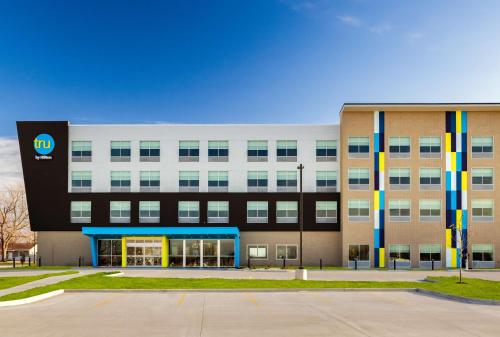 a building with a sign on the front of it at Tru By Hilton Oshkosh in Oshkosh