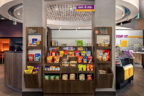 a grocery store with a display of food and drinks at Tru By Hilton Oshkosh in Oshkosh