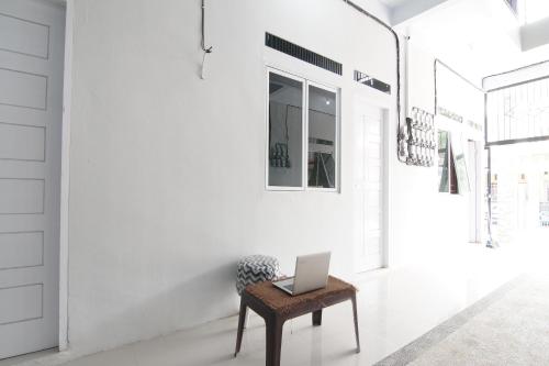 a laptop sitting on a table in a hallway at Hotel O 45 Guest House in Sragen