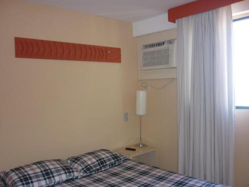 A bed or beds in a room at Boa Viagem Flat BVF 777