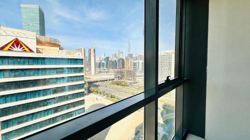 a view of a city skyline from a window at Luxury Studio Apartments Business Bay With Balcony and Free parking by Belvilla in Dubai