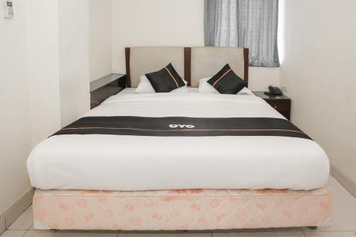 a bed in a room with a large white bed sidx sidx sidx sidx at Townhouse Oak J&b Gunung Sahari in Jakarta