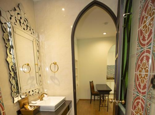 a bathroom with a sink and a mirror at The Grand Morocc Hotel in Mae Rim