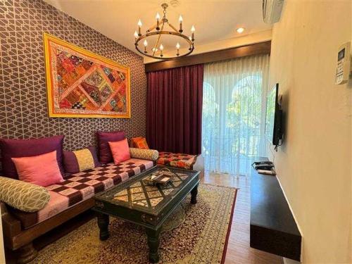 a living room with a couch and a table at The Grand Morocc Hotel in Mae Rim