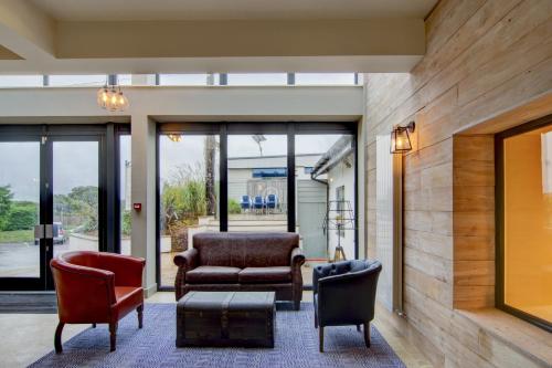 a living room with two chairs and a couch at The Gissons Hotel in Exeter