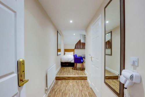 a hallway with a room with a bed and a mirror at The Gissons Hotel in Exeter