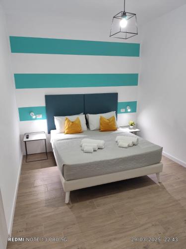 a bedroom with a bed with two pillows on it at La Perla Amantea - Rooms & Apartaments in Amantea