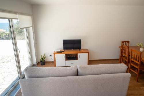 a living room with a couch and a tv at Seaing House II in Falca