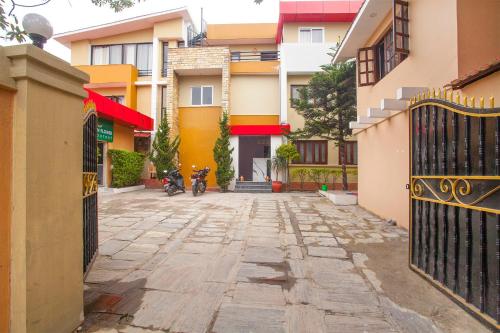an alley with a motorcycle parked in front of some buildings at OYO 817 Hotel Garden Flower in Kathmandu