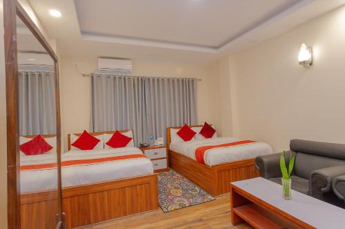 a hotel room with two beds and a couch at OYO 799 Hotel Tik Tok Pvt Ltd. in Kathmandu