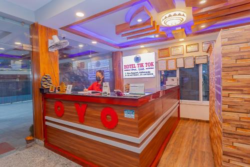 a man behind a counter in a fast food restaurant at OYO 799 Hotel Tik Tok Pvt Ltd. in Kathmandu