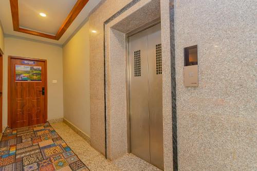 a hallway with a door and a tile floor at OYO 799 Hotel Tik Tok Pvt Ltd. in Kathmandu