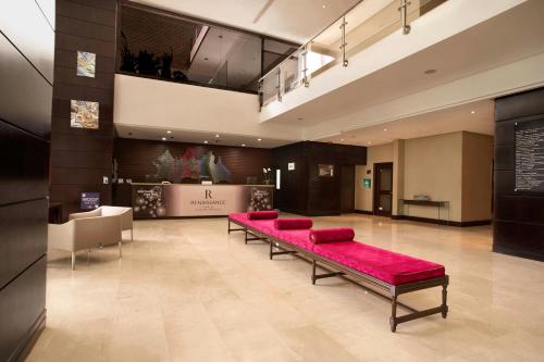 a room with a bench with red pillows in it at Renaissance Caracas La Castellana Hotel in Caracas