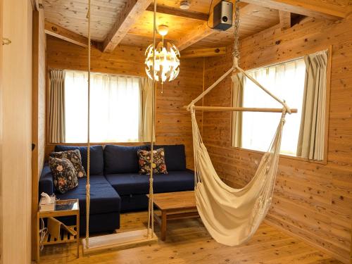 a living room with a hammock in a log cabin at 有馬ヴィラ木の家 1日1組限定 貸し切りのリバーサイドヴィラ in Kobe