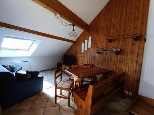 un salon avec une table et un canapé dans l'établissement Résidence Palathium - Grand appartement duplex pour 4 à 6 personnes - Terrasse TROPEZIENNE plein sud - Vue pistes. MAE-8354, à Montgenèvre