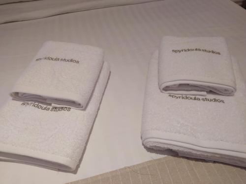 two towels are sitting on a white table at Spyridoula Studio 12 in Paleokastritsa