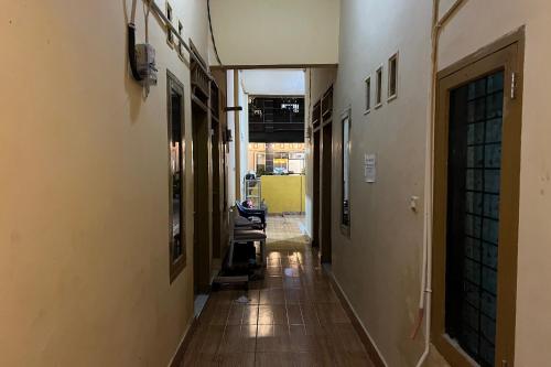 an empty hallway with chairs in a building at Hotel O Kos Rian in Sungguminasa