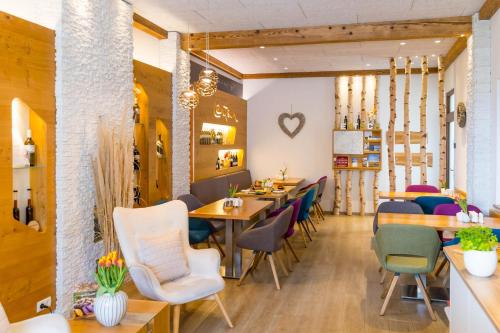 a restaurant with tables and chairs and a heart on the wall at Winzerhof Lentsch in Jois