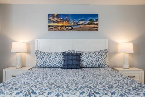 a bedroom with a white bed with two night stands at Wailea Hidden Gem in Wailea